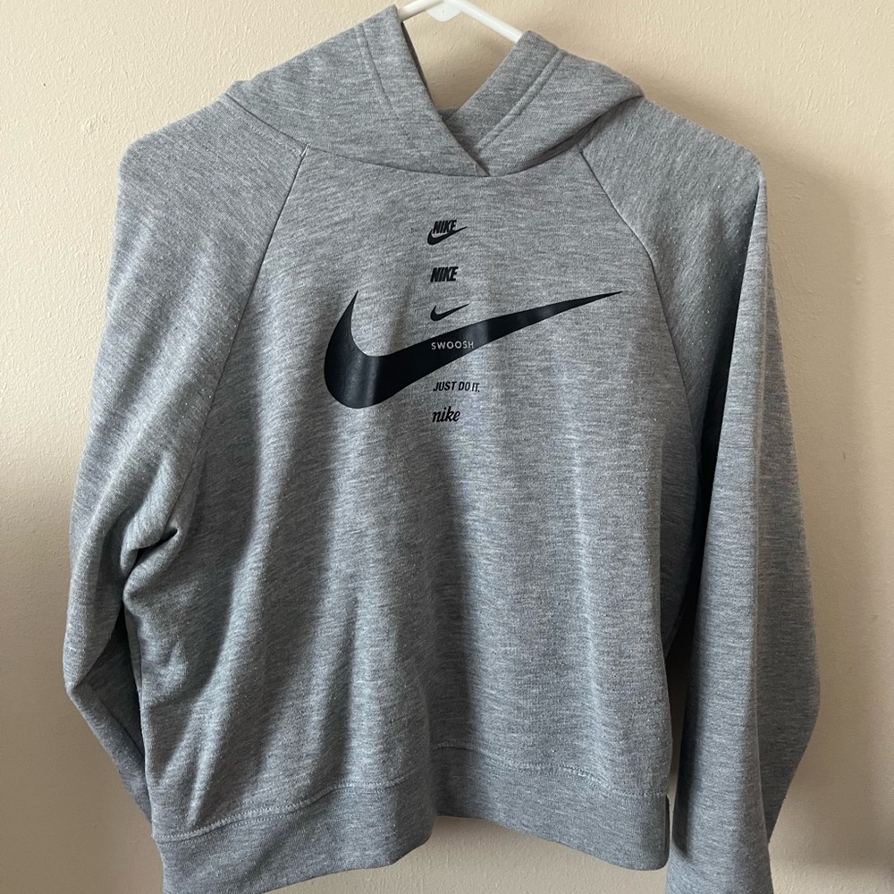 Gray Nike hoodie, cropped.